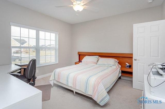 bedroom with ceiling fan and light carpet