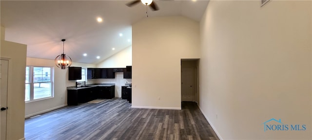 kitchen with dark hardwood / wood-style flooring, high vaulted ceiling, and ceiling fan with notable chandelier