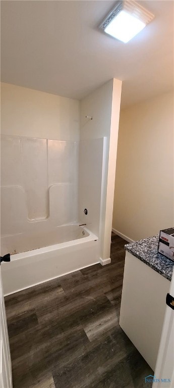 bathroom with hardwood / wood-style floors, vanity, and shower / tub combination