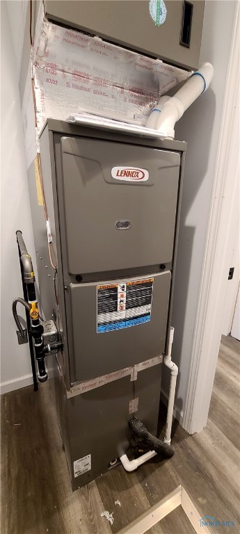 utility room featuring heating unit