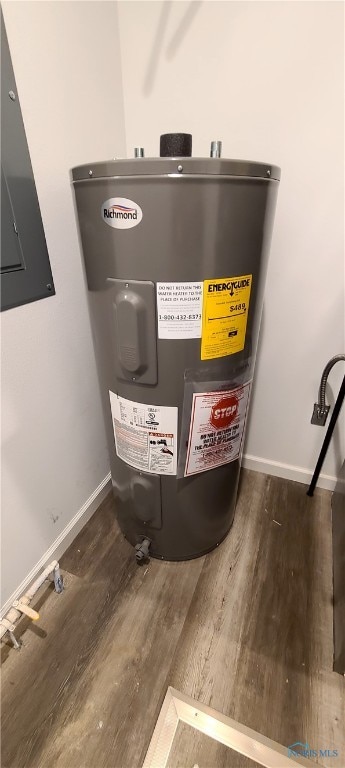 utility room with electric water heater and electric panel