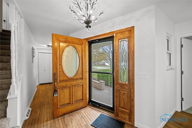 foyer featuring light hardwood / wood-style flooring and a notable chandelier