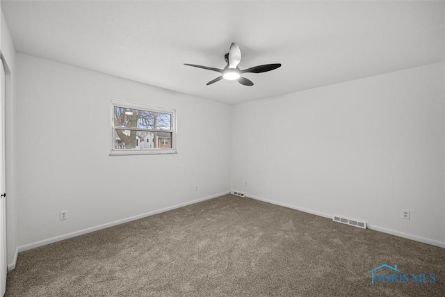 carpeted spare room with ceiling fan