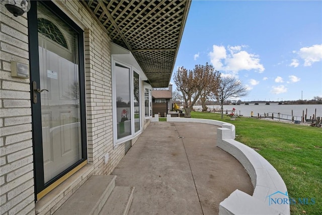 view of patio with a water view