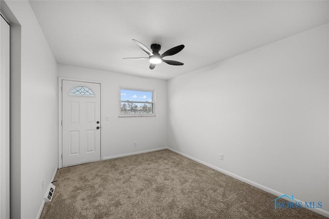 carpeted spare room featuring ceiling fan