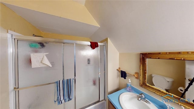 full bathroom featuring vanity, toilet, enclosed tub / shower combo, and vaulted ceiling