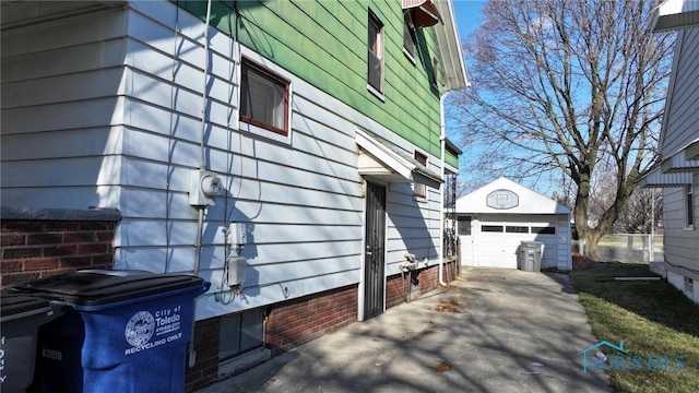 view of side of property featuring a garage and an outbuilding