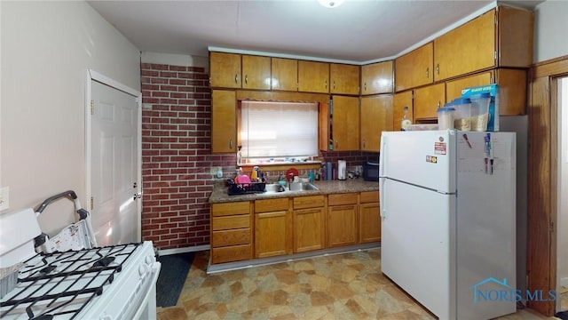 kitchen featuring white appliances, sink, and tasteful backsplash