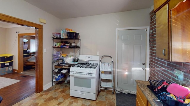 kitchen featuring light hardwood / wood-style flooring and white range with gas cooktop