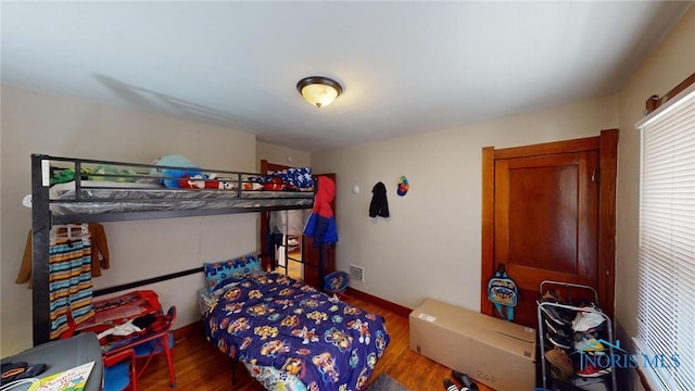 bedroom with wood-type flooring