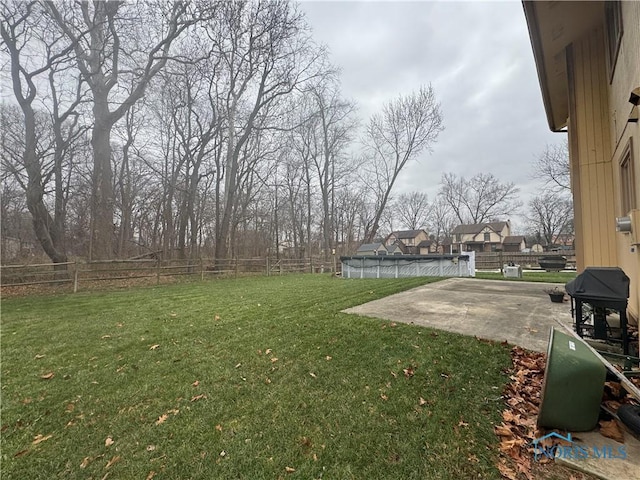 view of yard featuring a swimming pool and a patio