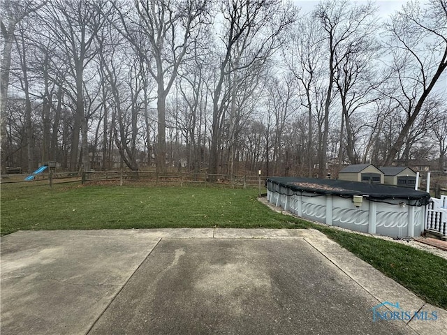 view of yard featuring a patio area and a covered pool