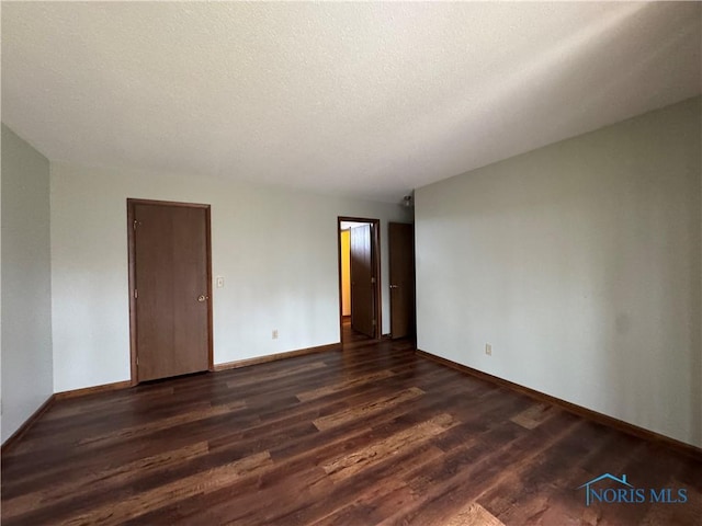 unfurnished room featuring dark hardwood / wood-style flooring