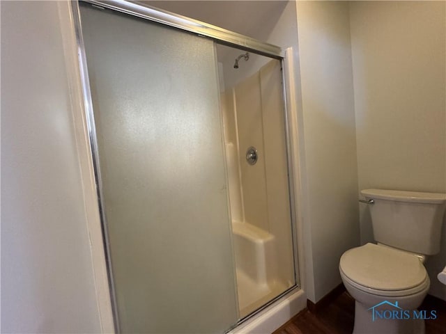 bathroom featuring toilet and walk in shower