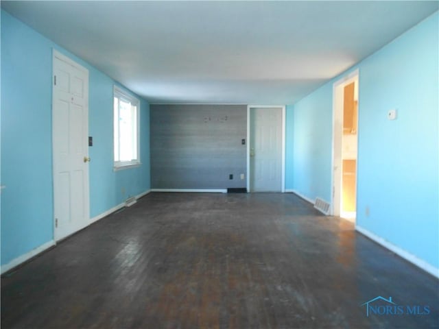 spare room featuring dark hardwood / wood-style floors