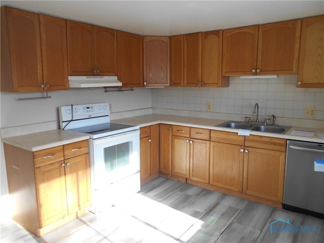 kitchen with backsplash, sink, electric range, stainless steel dishwasher, and light hardwood / wood-style floors