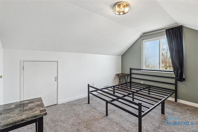 carpeted bedroom with lofted ceiling