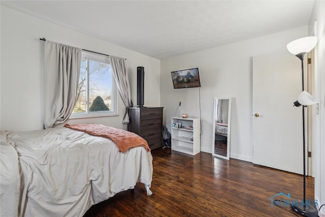 bedroom with dark hardwood / wood-style floors