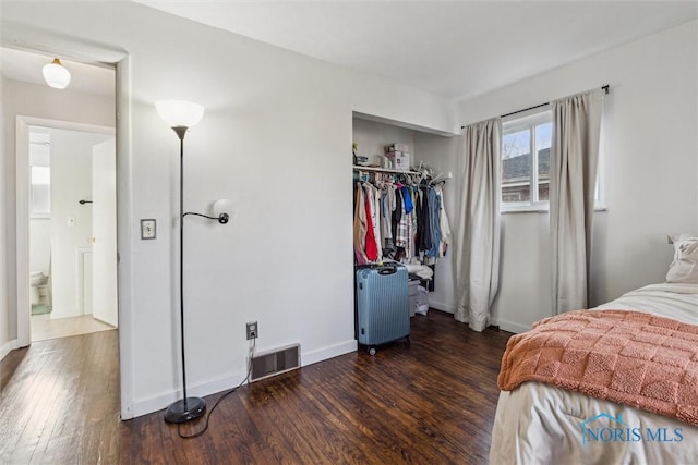 bedroom featuring dark hardwood / wood-style floors and a closet