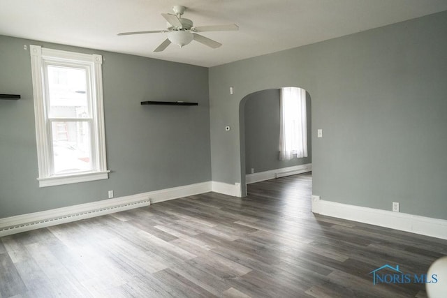 empty room with ceiling fan and dark wood-type flooring