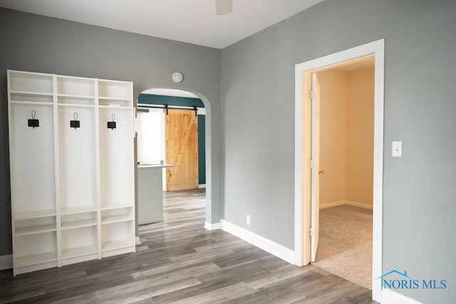 mudroom featuring hardwood / wood-style flooring and a barn door