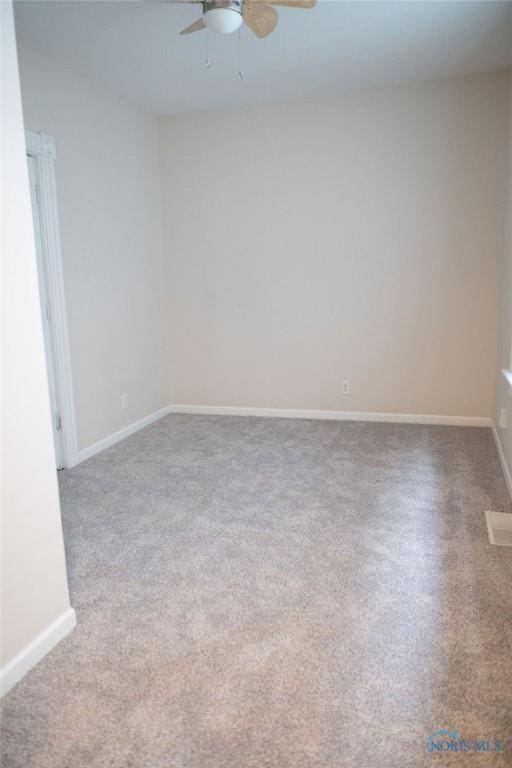 unfurnished room featuring ceiling fan and carpet floors