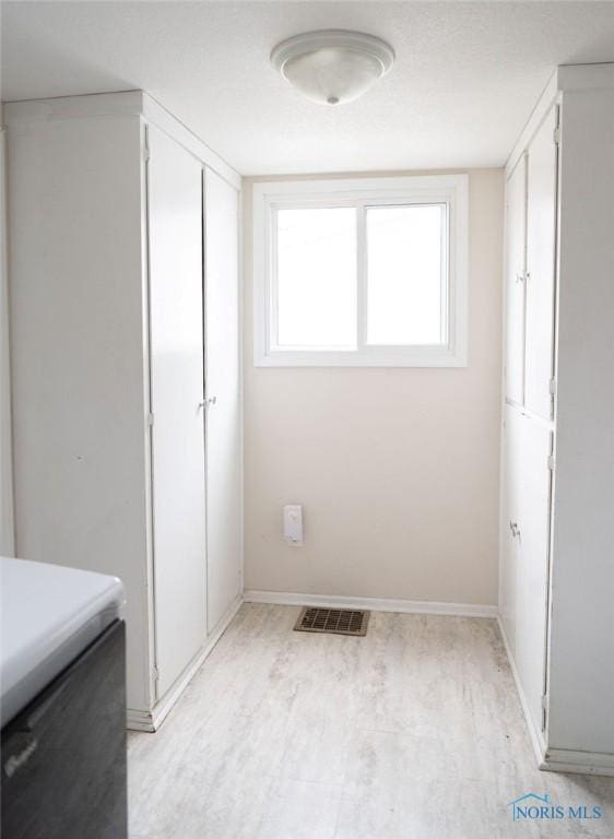 washroom with light wood-type flooring