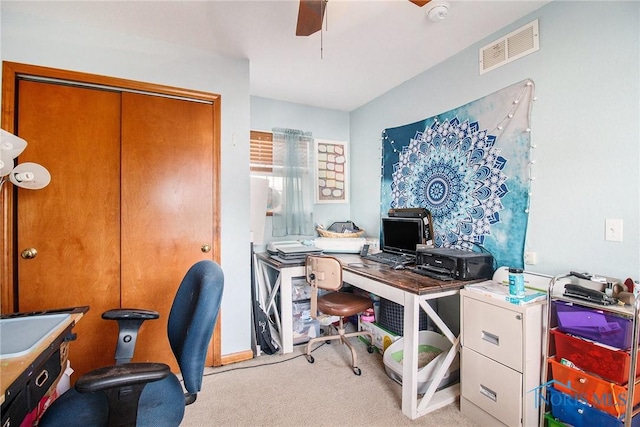 carpeted home office with ceiling fan