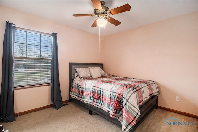 bedroom featuring light carpet and ceiling fan