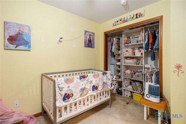 bedroom featuring light carpet, a closet, and a crib