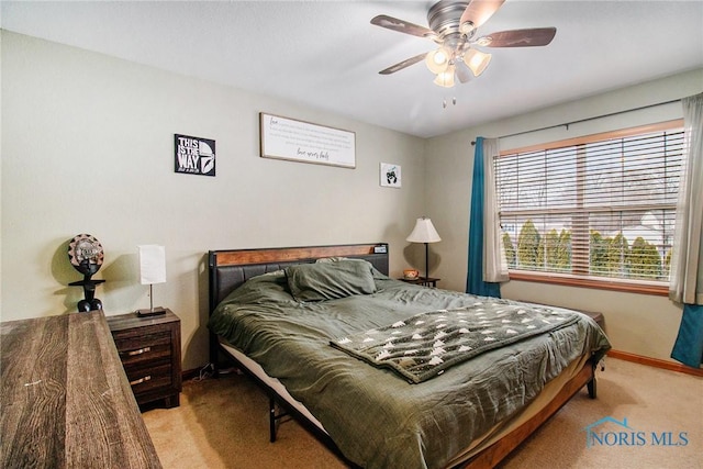 bedroom featuring ceiling fan and light colored carpet