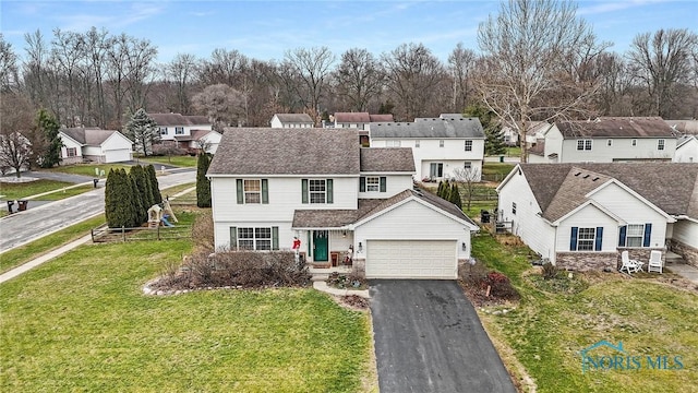 view of front of property featuring a garage and a front lawn