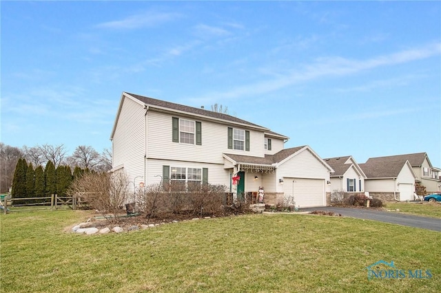 front of property featuring a front lawn and a garage