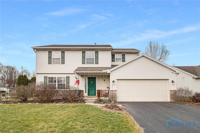 view of property featuring a front yard and a garage