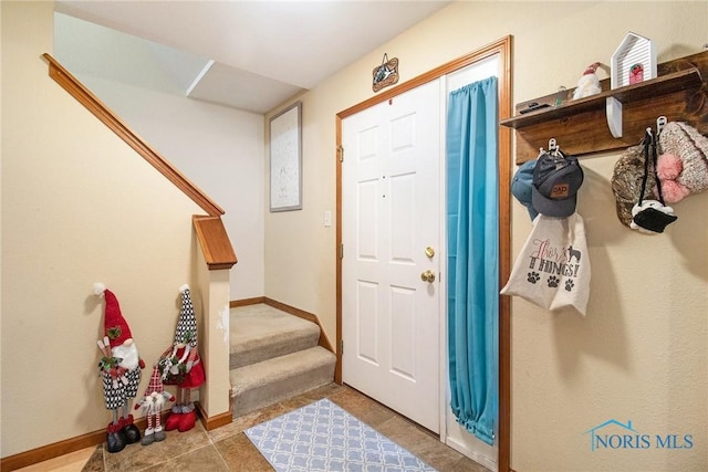 entryway with light tile patterned flooring