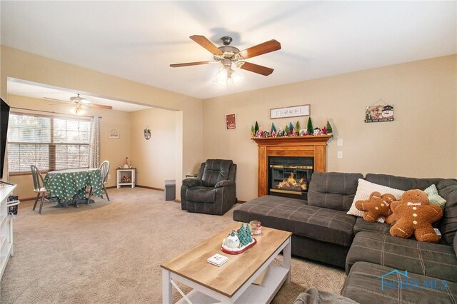 living room featuring light carpet and ceiling fan