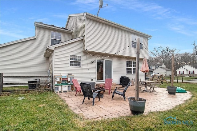 back of house with central AC, a patio, a fire pit, and a lawn