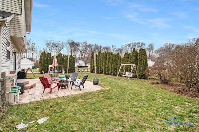 view of yard featuring a fire pit and a patio