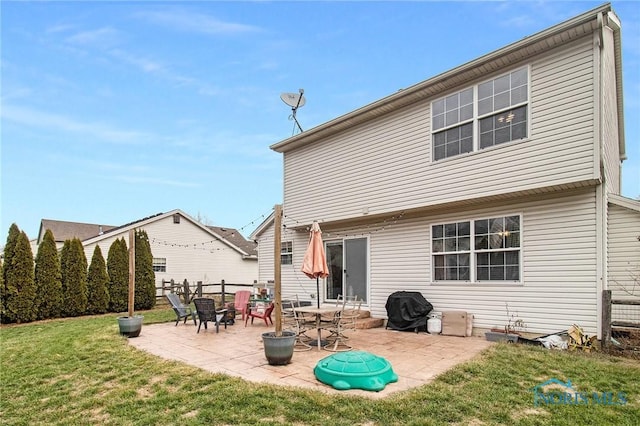 back of house with a yard and a patio area