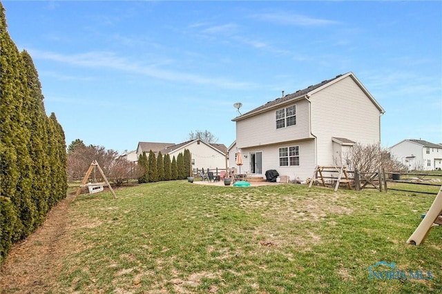 back of property with a patio area and a yard