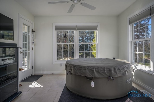 sunroom / solarium with ceiling fan and a wealth of natural light