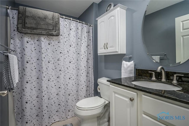 bathroom featuring tile patterned floors, curtained shower, vanity, and toilet