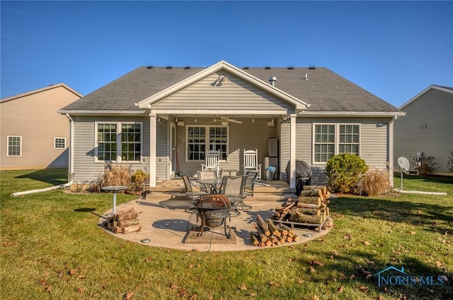 back of property featuring ceiling fan, a yard, and a patio