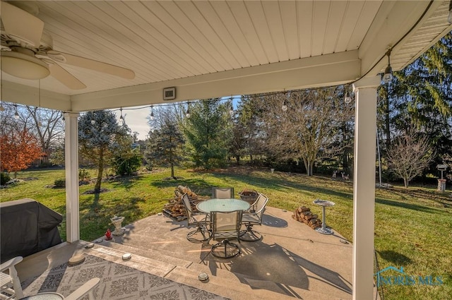 view of patio with area for grilling and ceiling fan