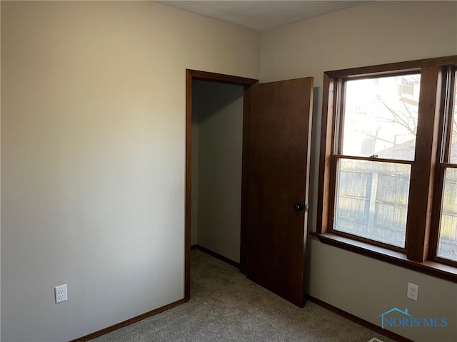 unfurnished bedroom featuring light colored carpet