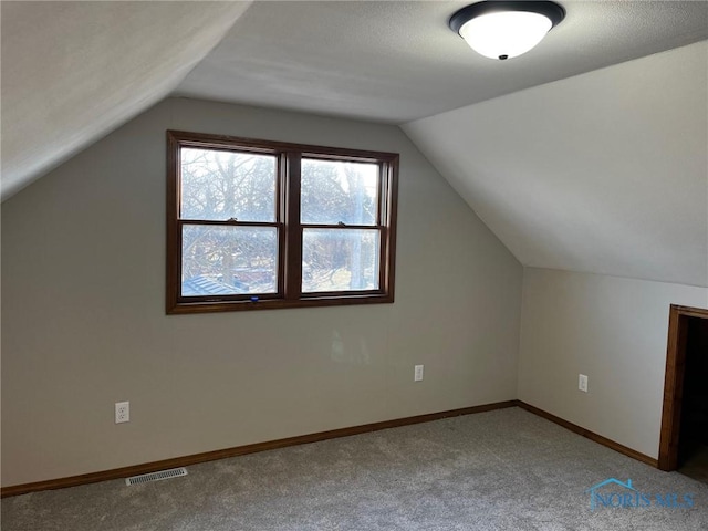 bonus room featuring carpet flooring and lofted ceiling