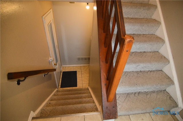 staircase with tile patterned floors