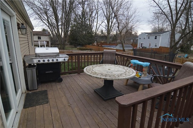 wooden terrace featuring a grill