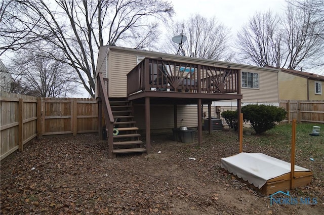 rear view of property featuring a wooden deck