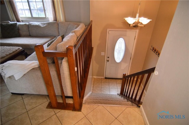 tiled entrance foyer featuring a chandelier